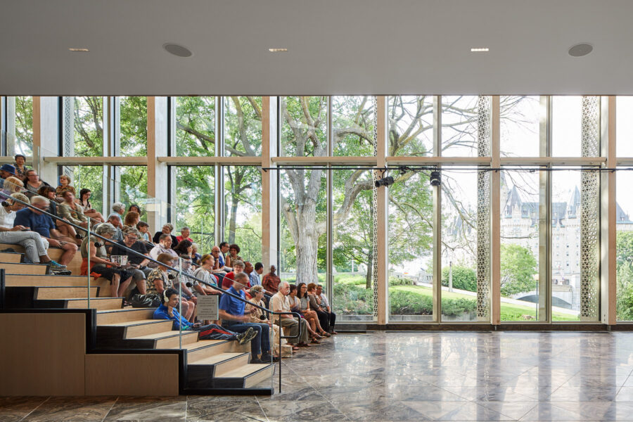 The National Art Gallery, shot of the interior lobby stairs facing towards the window with people sitting on them.